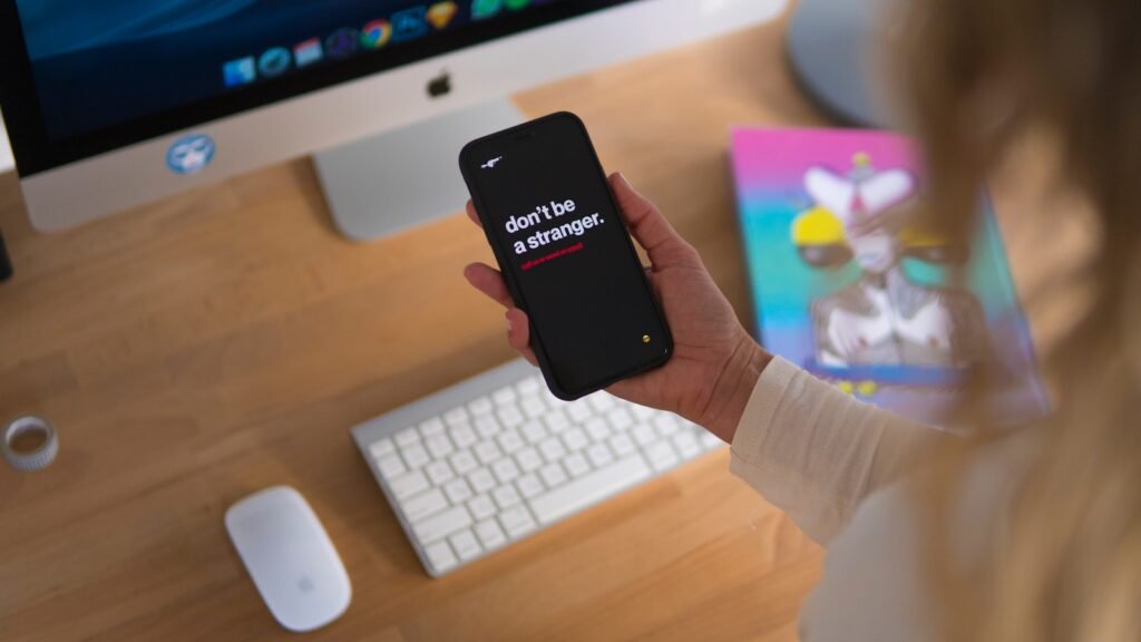 person holding black iPhone displaying don't be stranger